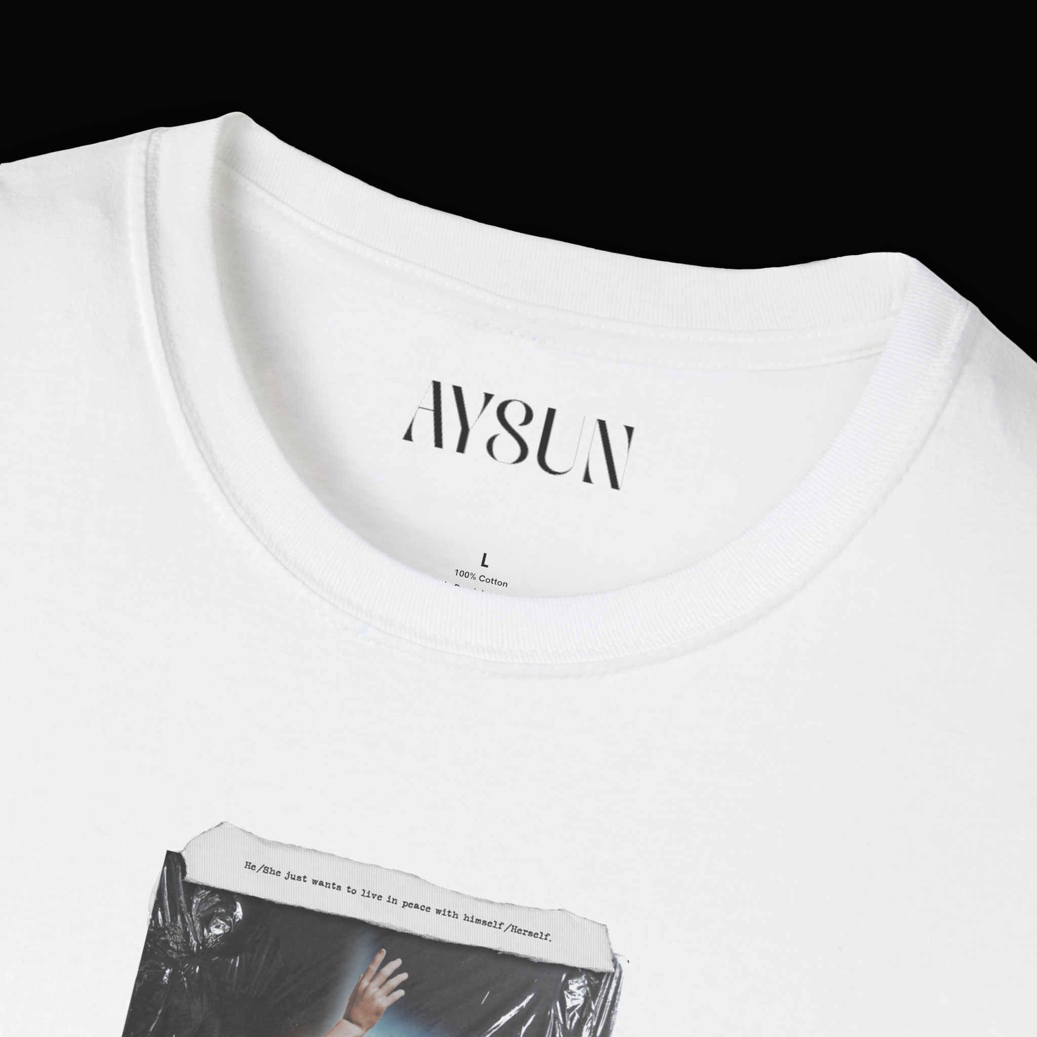 Person wearing a black t-shirt with a graphic design on a plain background