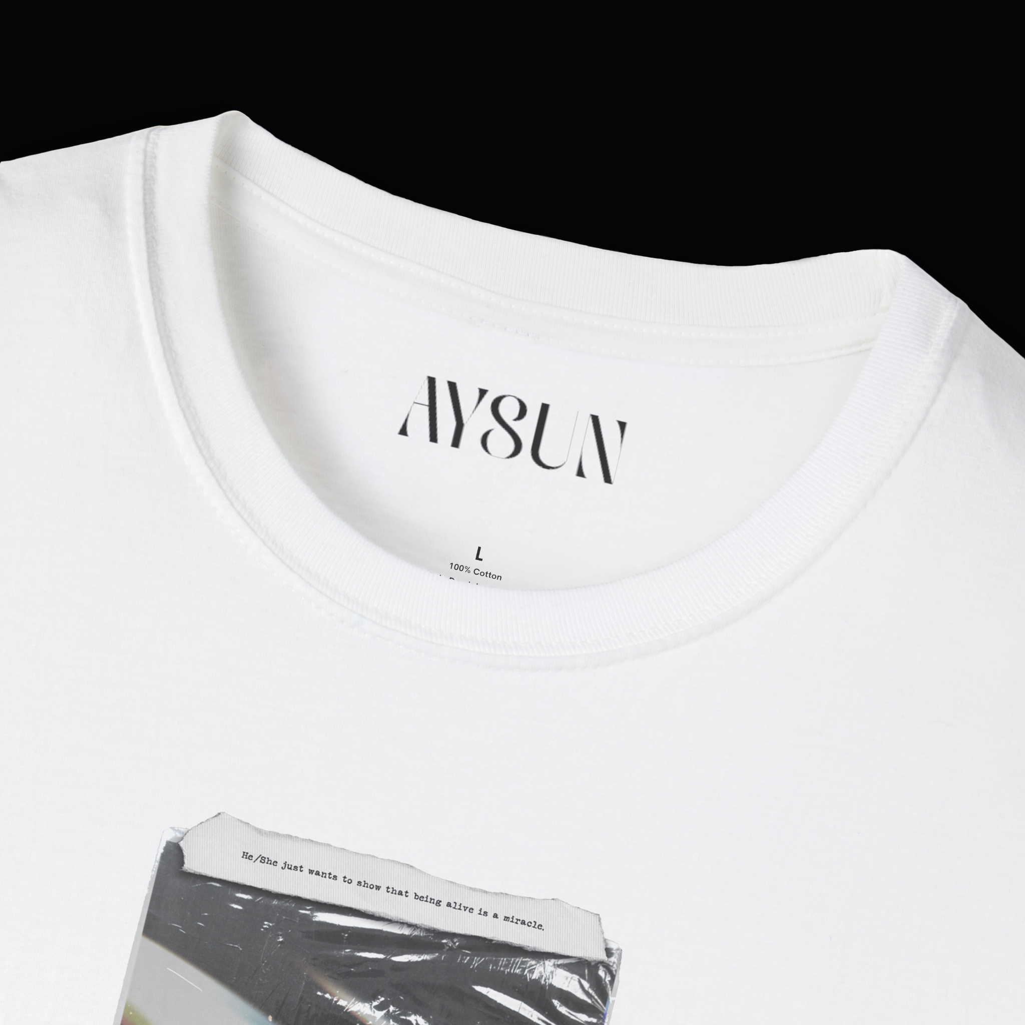 Woman wearing a black t-shirt with a graphic design and light blue jeans on a plain background