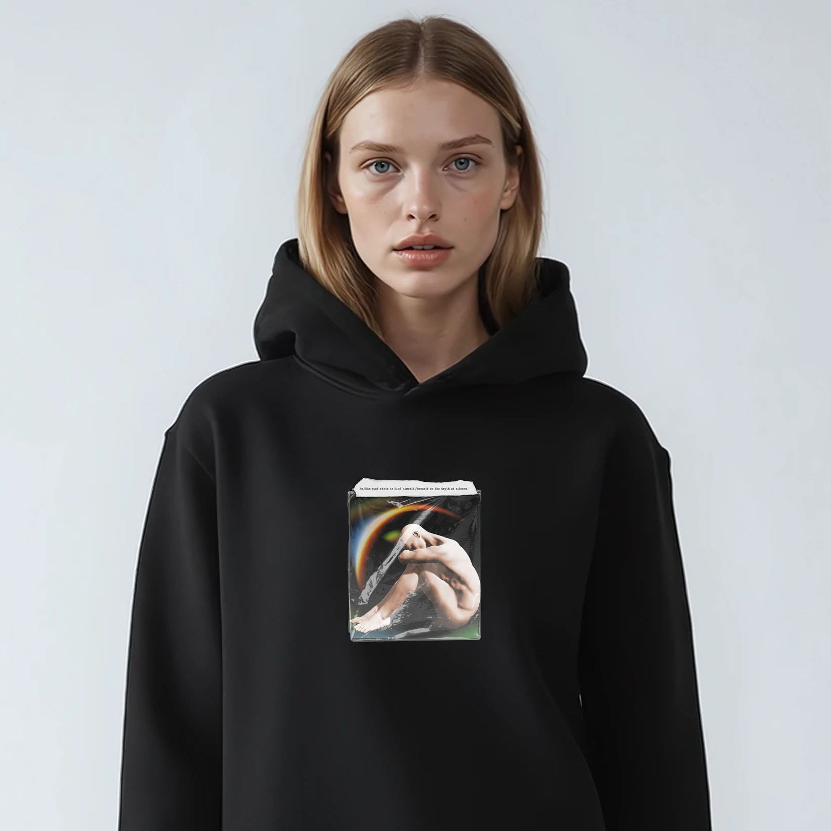 Person wearing a black hoodie with a graphic design on a white background