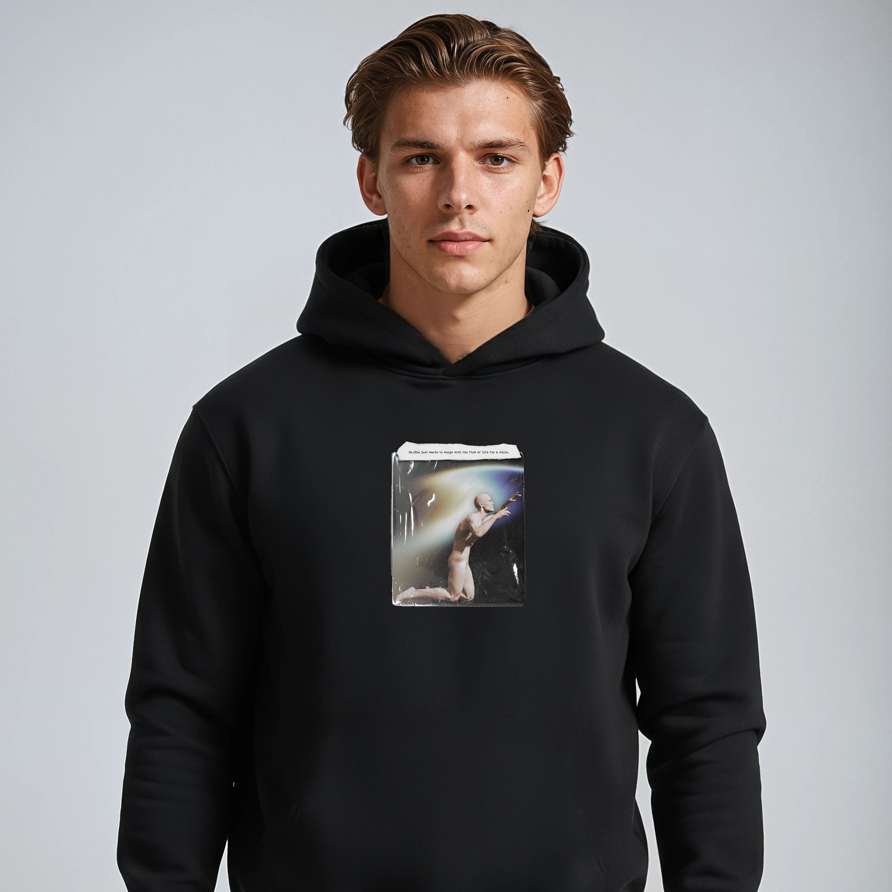 Person wearing a black hoodie with a graphic design on a gray background