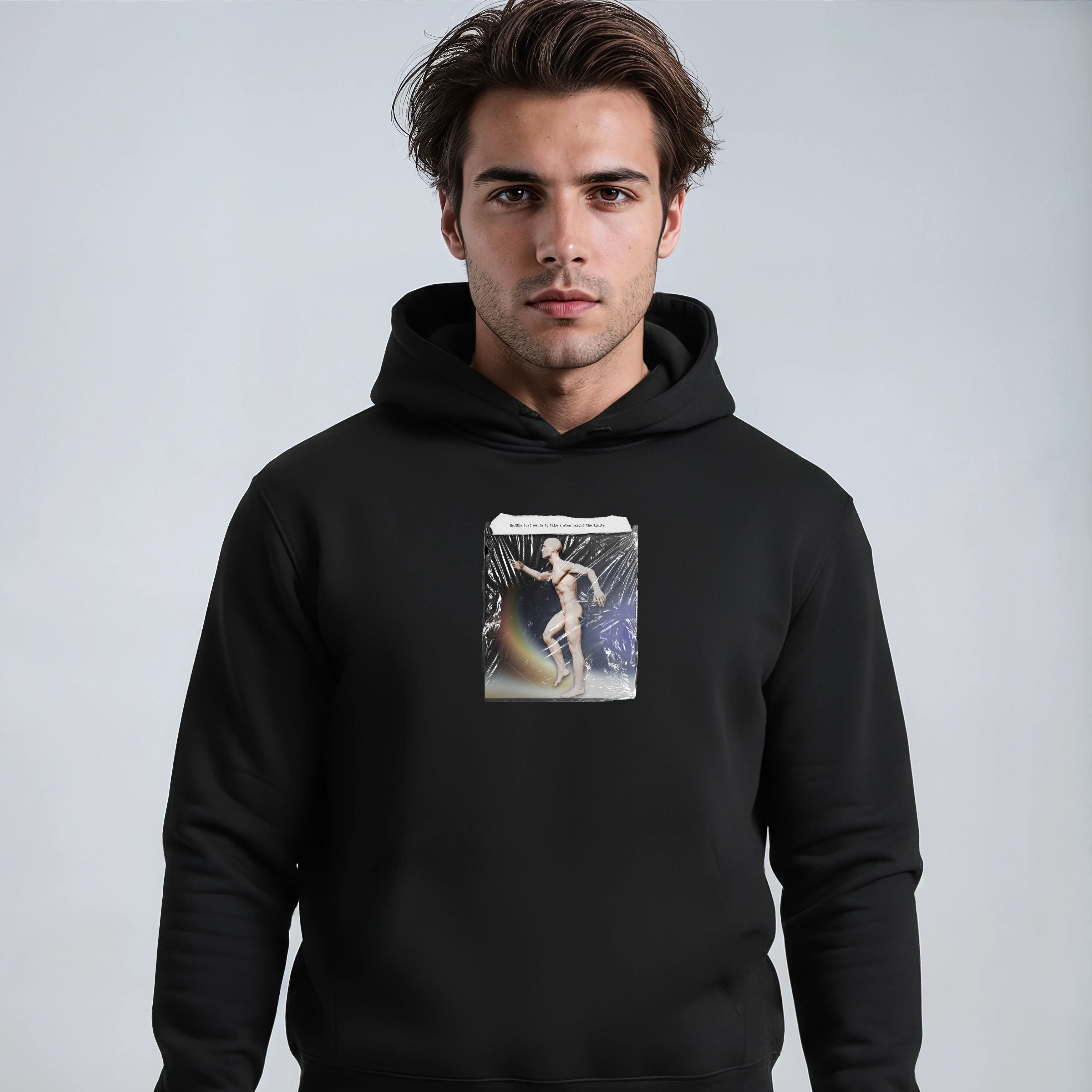 Man wearing a black hoodie with a graphic design on a light gray background