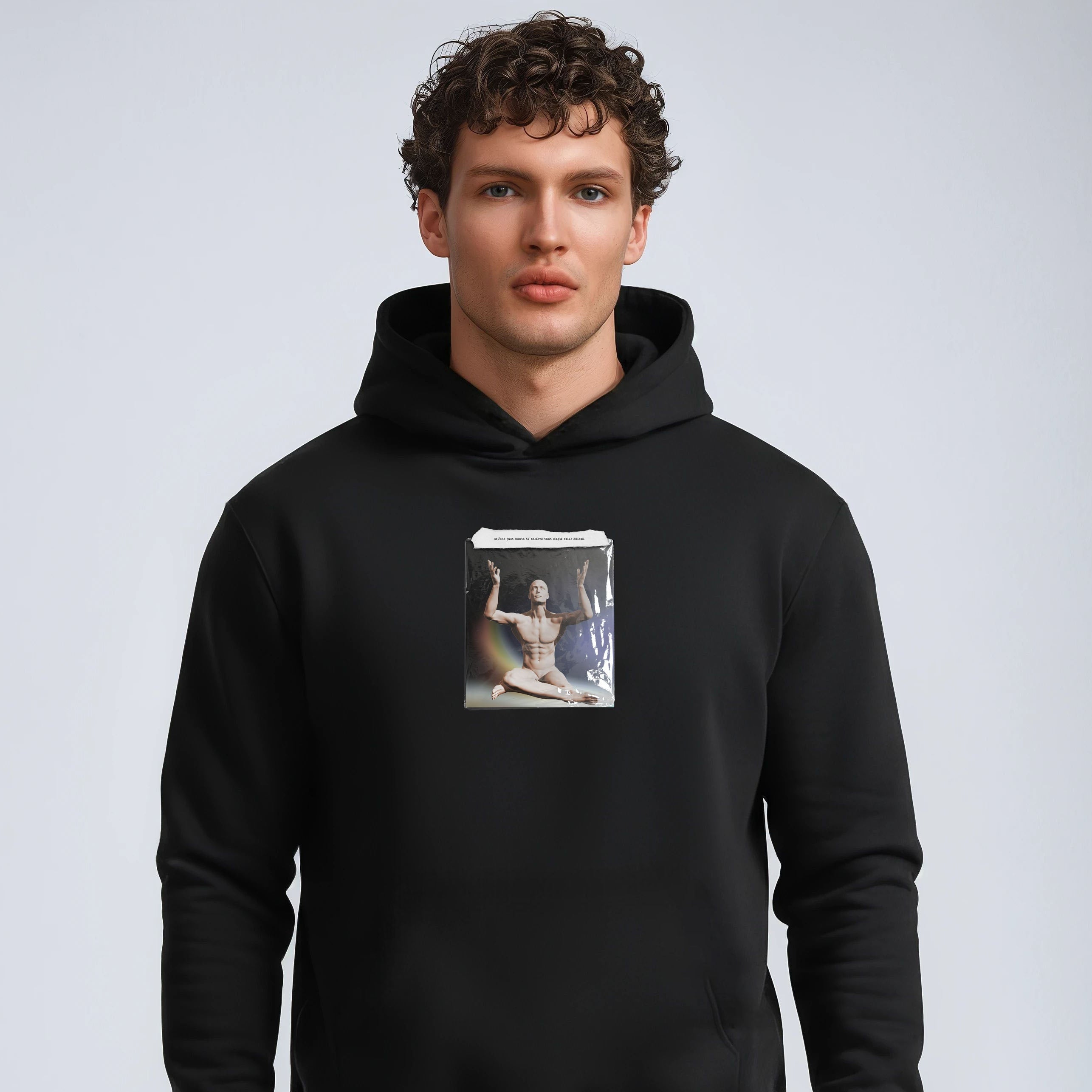 Man wearing a black hoodie with a graphic design on a plain background