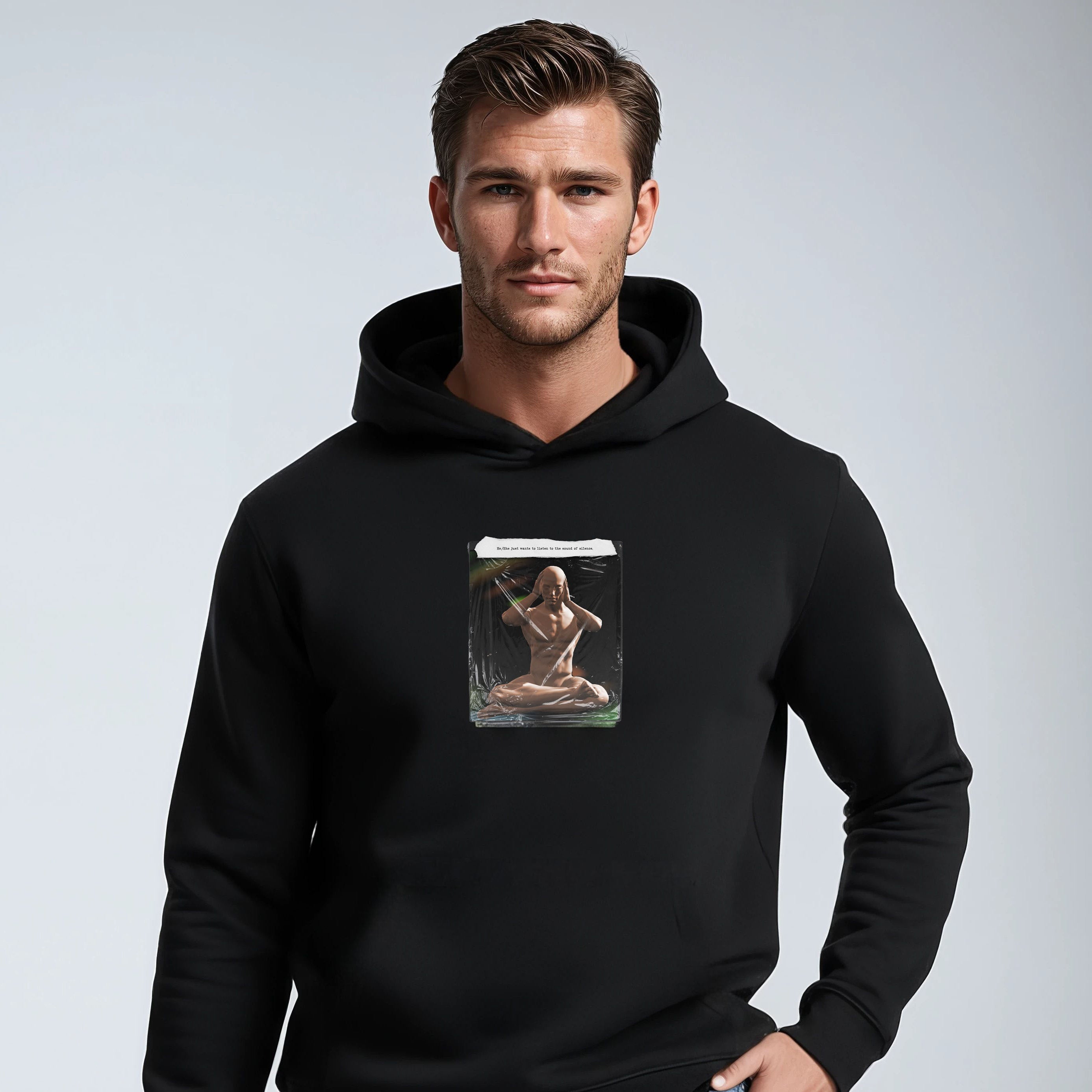 Man wearing a black hoodie with a graphic design on a light gray background