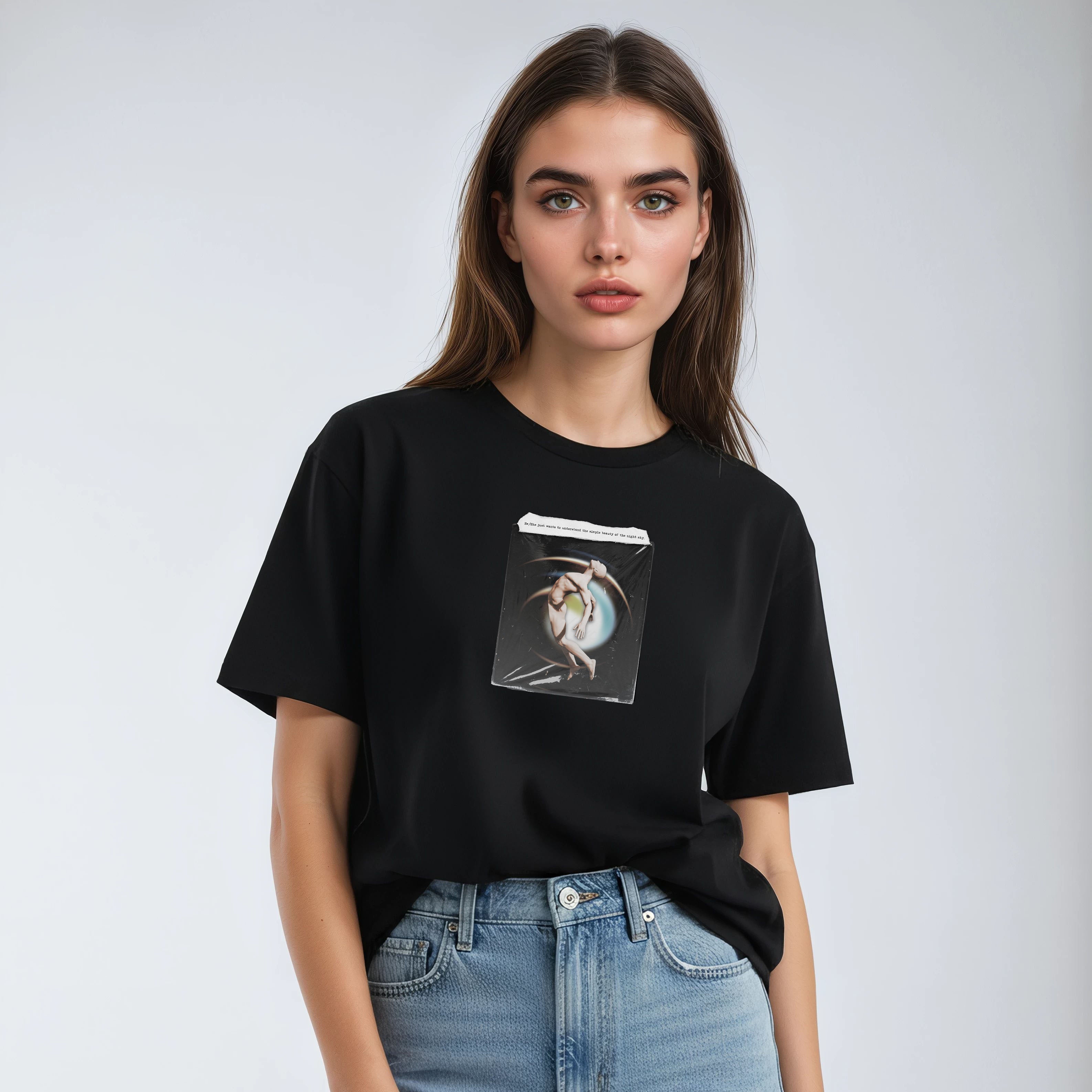 Person wearing a black t-shirt with a graphic design and light blue jeans on a white background