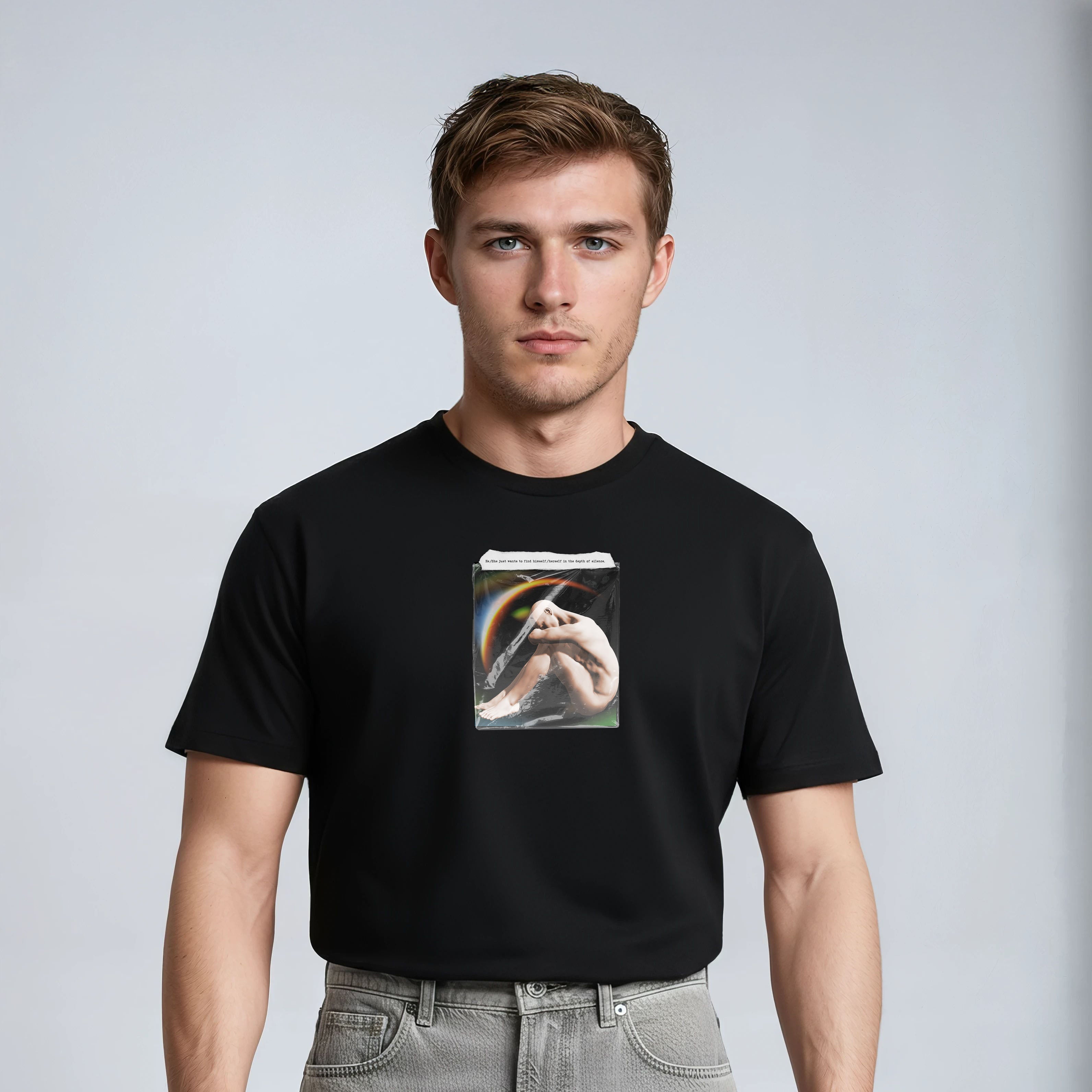 Man wearing a black t-shirt with a graphic design on a plain background