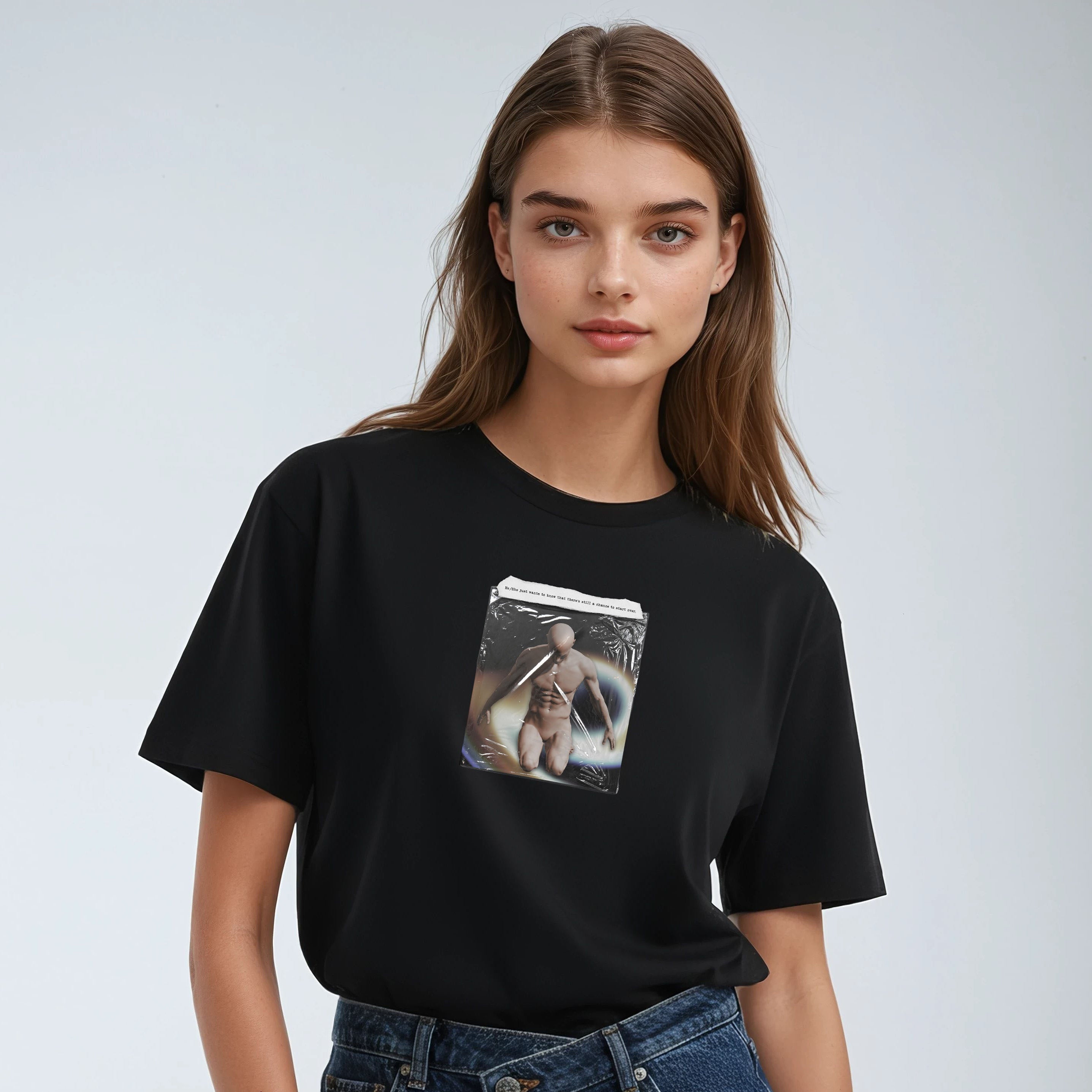 Person wearing a black t-shirt with a graphic design on a plain background