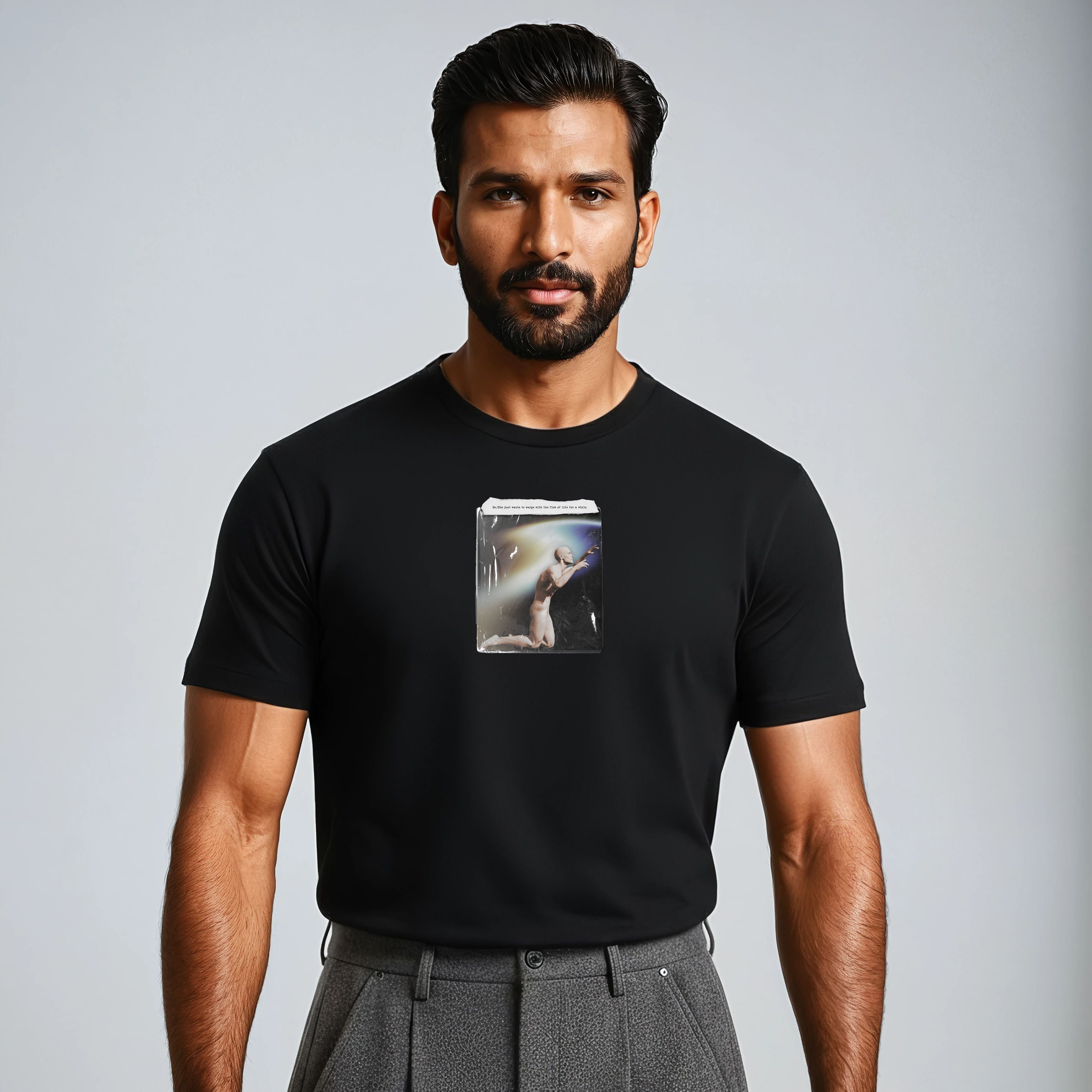 Man wearing a black t-shirt with a graphic design on a gray background