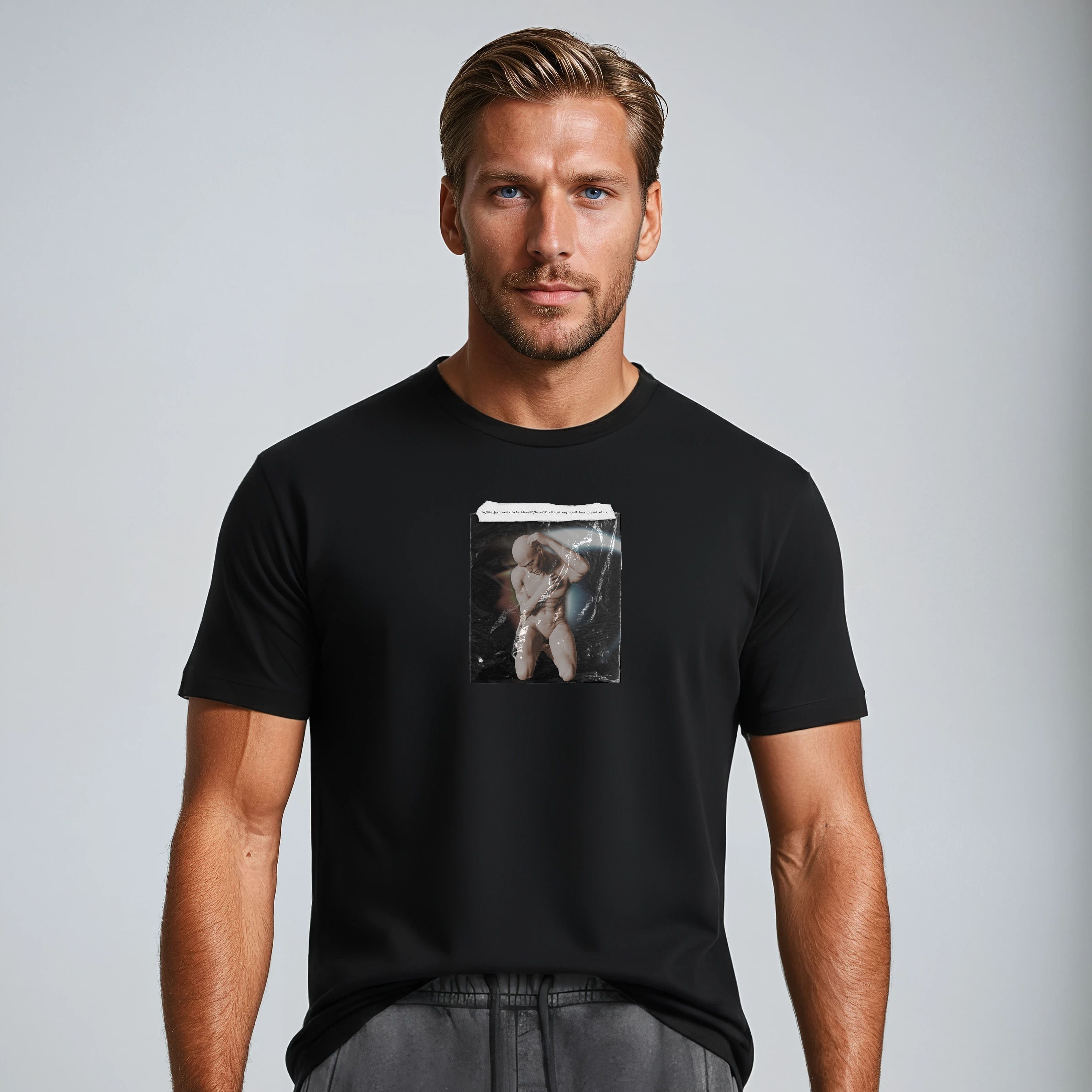 Man wearing a black t-shirt with a graphic design on a gray background