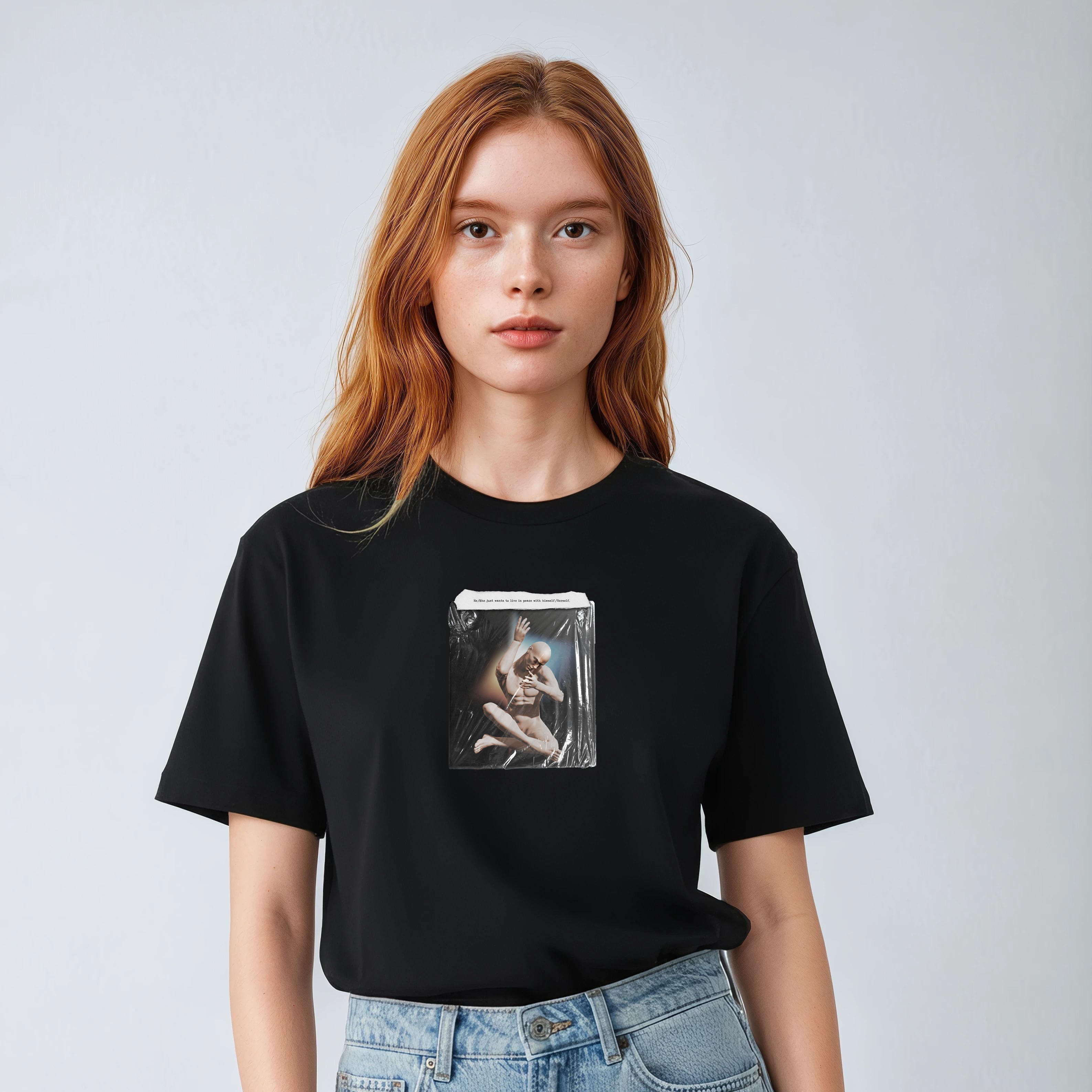 Person wearing a black t-shirt with a graphic design on a plain background